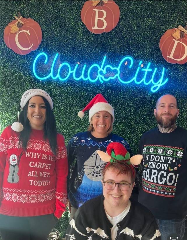 Cloud City Staff wearing holiday sweaters.